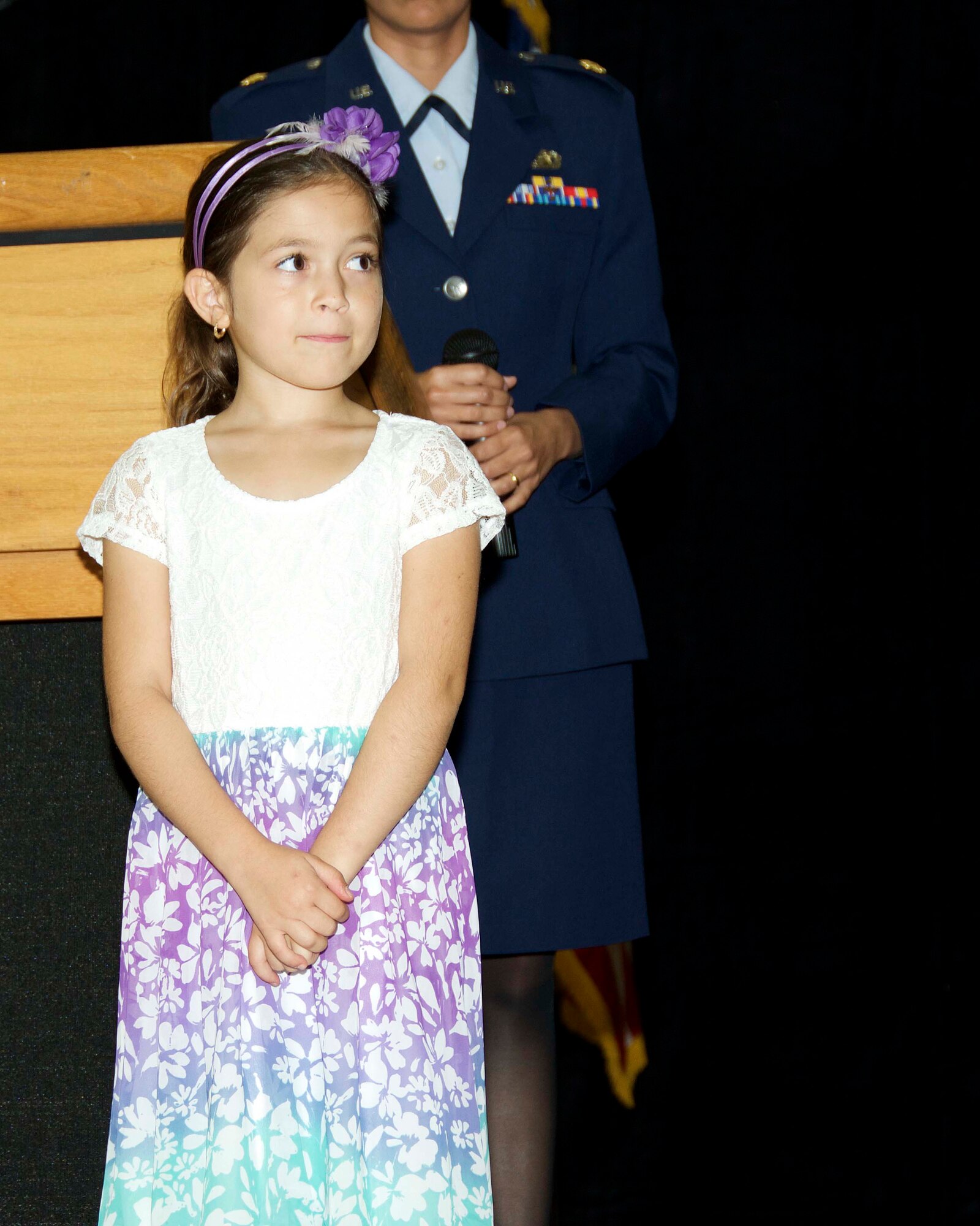 Seven-year-old Isabelle Alaina Simpson, daughter of Staff Sgt. Veronica Simpson, sings the National Anthem during a ceremony where Brig. Gen. Christian G. Funk, 482nd Fighter Wing commander, was officially promoted to the rank of brigadier general at Homestead Air Reserve Base, Fla., April 11. (U.S. Air Force photo by Staff Sgt. Jaimi L. Upthegrove)