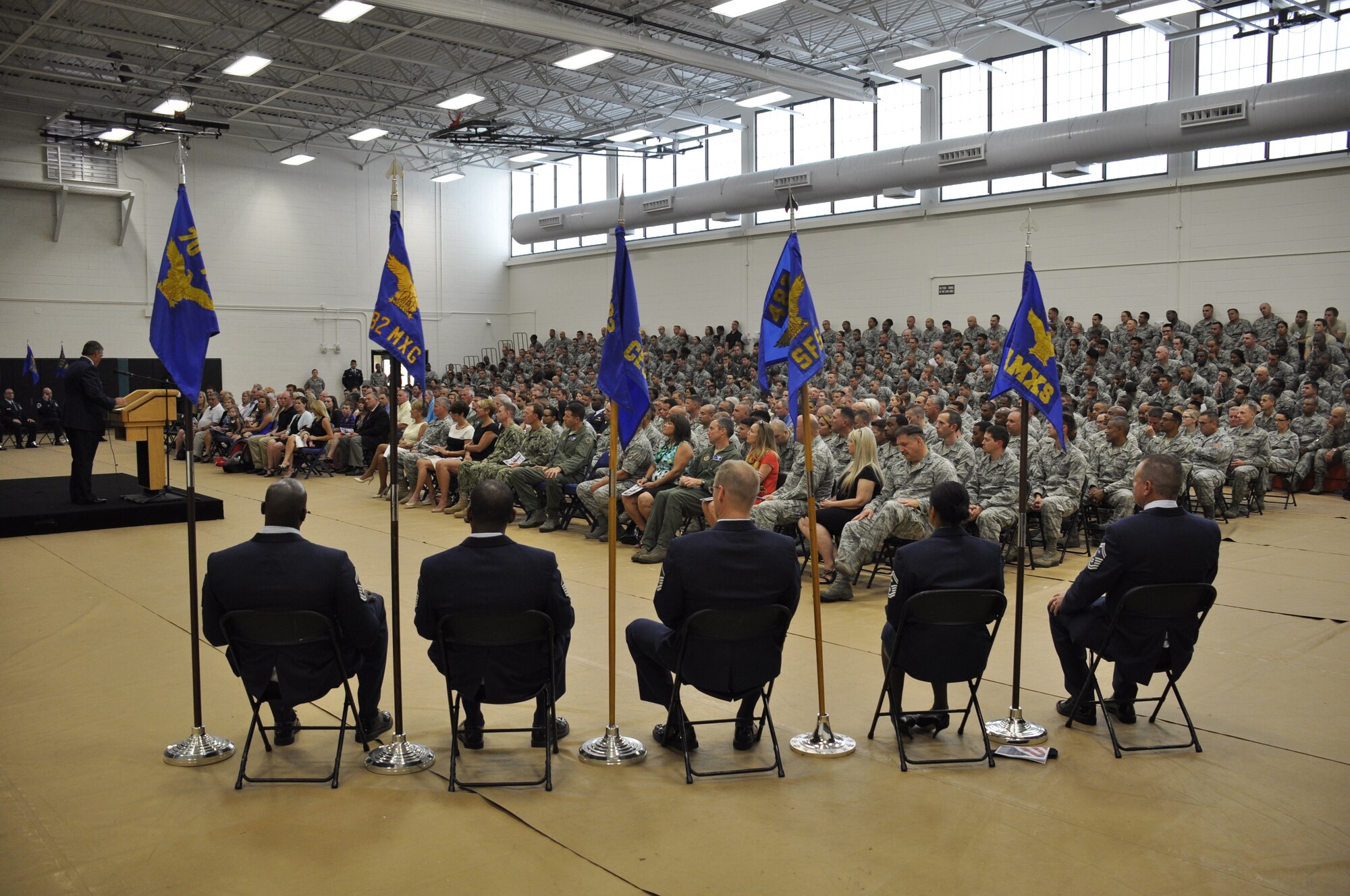 Designated representatives sit next to their guidon during a promotion ceremony at Homestead Air Reserve Base, Fla., April 11. During the ceremony, Brig. Gen. Christian G. Funk, the 482nd Fighter Wing commander was officially promoted to the rank of brigadier general. (U.S. Air Force photo by Senior Airman Nicholas Caceres)