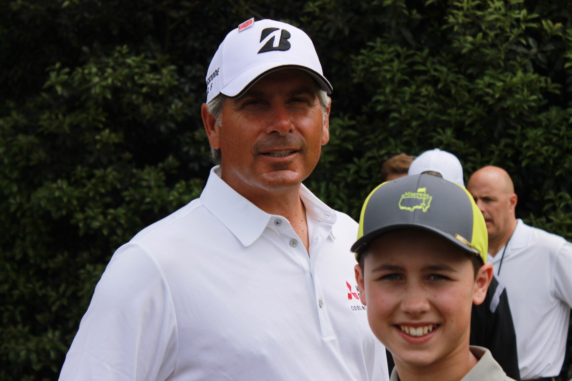 Jason Cruise, Jr., son of Jason Cruise, 55th Civil Engineer Squadron, and Collette Cruise, U.S. Strategic Command at Offutt pauses to take a photo with Fred Couples at the 2015 Drive, Chip and Putt Championship at Augusta National Golf Club right before The Masters. Junior placed 9th out of 80 competitors in the competition. (Courtesy Photo)