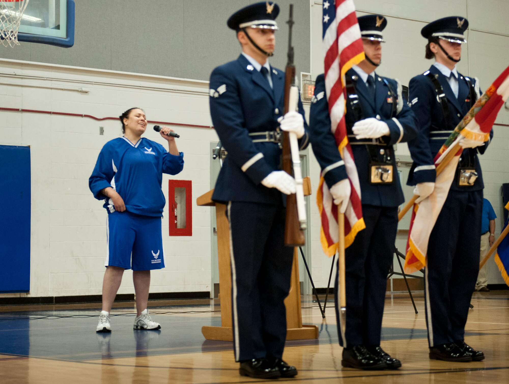 Jen Stone, a Wounded Warrior athlete, sings the National Anthem during the opening ceremony of the Air Force introductory adaptive sports and rehabilitation camp at Eglin Air Force Base, Fla., April 13. The DOD’s military adaptive sports program enhances warrior recovery by engaging wounded, ill and injured service members in ongoing, daily adaptive activities, based on their interest and ability. This is the first event of the type to be held at Eglin. (U.S. Air Force photo/Samuel King Jr.)