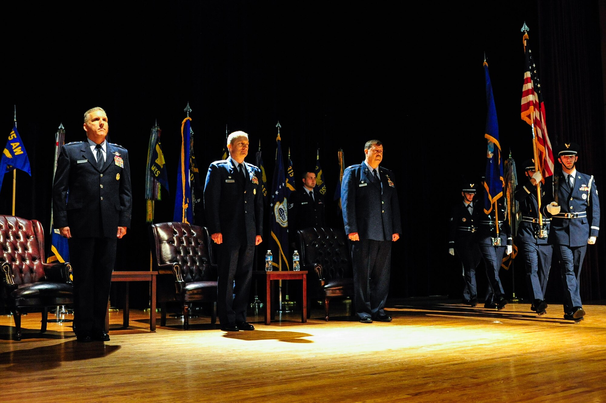 The 315th Airlift Wing change of command ceremony gets underway at the Joint Base Charleston theater March 11, 2015.  Maj. Gen. John C. Flournoy, Jr., commander 4th Air Force, presided over the ceremony where Col. Greg Gilmour assumed command of the 315th AW from Col. James Fontanella. Gilmour was previously the commander of the 916th Air Refueling Wing at Seymour Johnson Air Force Base in North Carolina, and Fontanella, outgoing commander, is headed  to Robins Air Force Base, Georgia as the commander of the Air Force Reserve Force Generation Center. (U.S. Air Force Photo by Staff Sgt. Bobby Pilch)