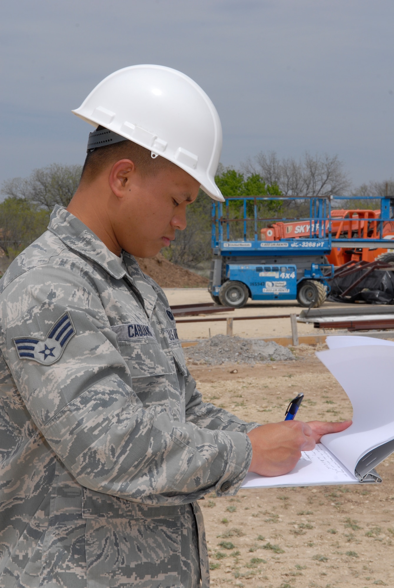 GOODFELLOW AIR FORCE BASE, Texas--Senior Airmen Angelo Mykael Cabuang, 17th Contracting Squadron contract specialist, takes notes while inspecting the progress on a construction site Apr 2. The inspection ensures the contractors are making progress, doing the work outlined in the contract and follow safety procedures. (U.S. Air Force photo/ Joseph Mather)