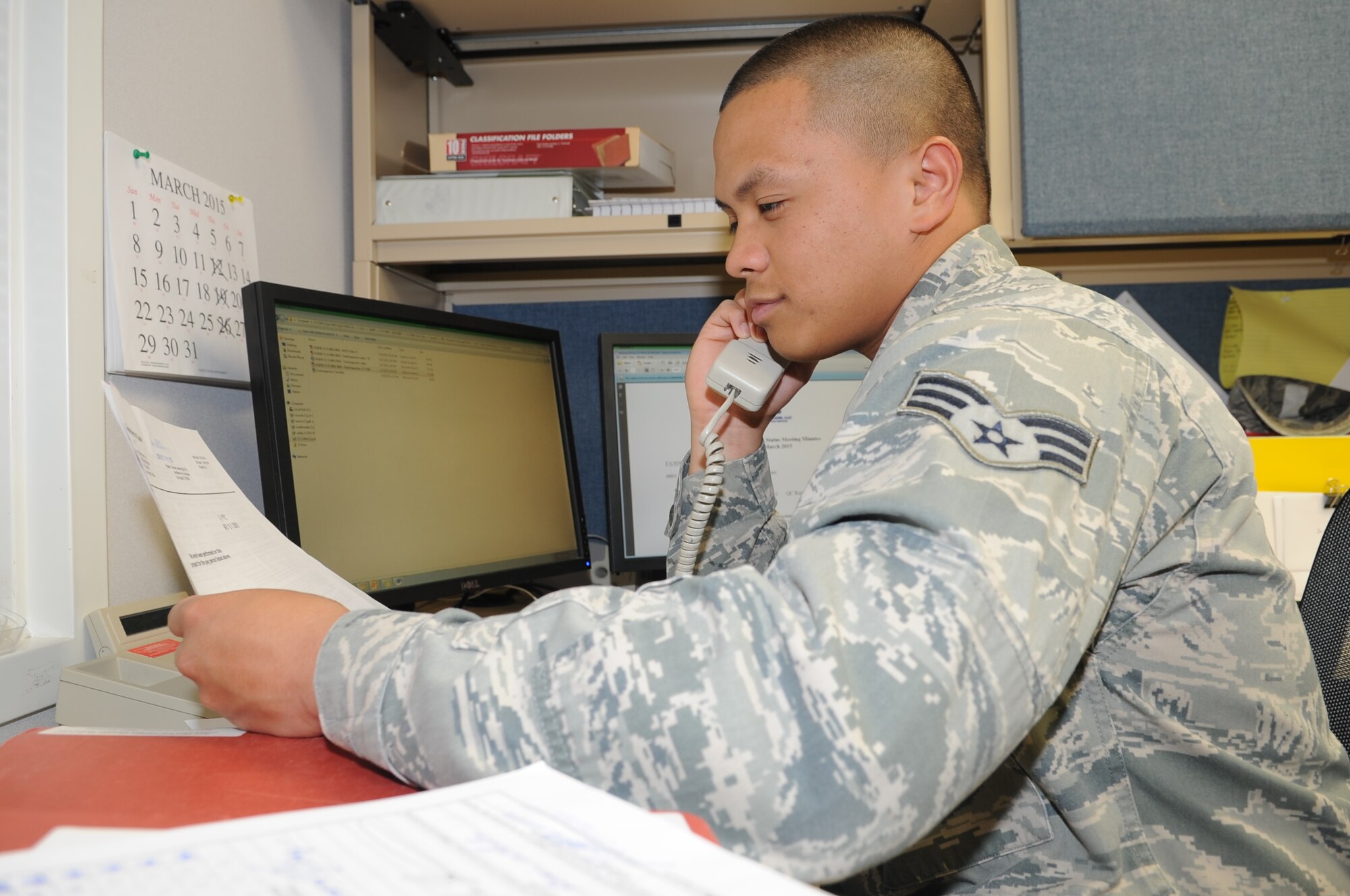 GOODFELLOW AIR FORCE BASE, Texas--Senior Airmen Angelo Mykael Cabuang, 17th Contracting Squadron contract specialist, discusses the details of an acquisition package with a customer Apr. 1. He ensures all documentation in the contract is correct with the customer before it proceeds to the contracting officer. (U.S. Air Force photo/ Joseph Mather)