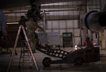 Airmen from the 5th Aircraft Maintenance Squadron load an M-117 bomb onto a B-52H Stratofortress on Minot Air Force, N.D., April 8, 2015. These Airmen worked mid-shift, which is from midnight to 8 a.m. (U.S. Air Force photo/Airman 1st Class Apryl Hall)