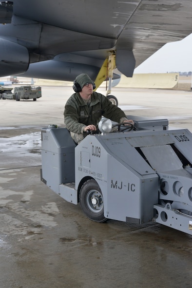 Airman 1st Class Michael McCay, 5th Aircraft Maintenance Squadron weapons load crew team member, drives a MJ-1 bomb lift on Minot Air Force Base, N.D., April 8, 2015. The truck is used to safely maneuver and transport munitions to be placed inside a B-52H Stratofortress. (U.S. Air Force photo/Senior Airman Malia Jenkins) 