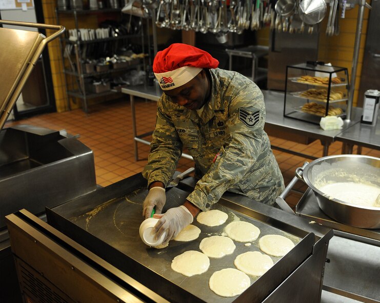 Staff Sgt. Ralaun Kidd, 5th Force Support Squadron shift supervisor, prepares pancakes for breakfast on Minot Air Force Base, N.D., April 8, 2015. The dining facility staff is committed to providing Airmen with a wide variety of homemade meals.  (U.S. Air Force photo/Senior Airman Kristoffer Kaubisch)