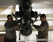 Staff Sgt. Eric Hathaway, 5th Aircraft Maintenance squadron weapons load crew team chief and Senior Airman Chaz Geurrero, 5th aircraft maintenance squadron weapons load crew member secure a MJ-1 bomb onto a B-52H Stratofortress on Minot Air Force Base, N.D., April 8, 2015. The 5th AMXS weapons section is responsible for ensuring the reliability and safe handling of all explosive devices or countermeasures loaded on the B-52H Stratofortress. (U.S. Air Force photo/Senior Airman Kristoffer Kaubisch)