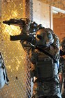 Senior Airman Ian Briggs, 791st Missile Security Forces Squadron tactical response force member, cuts through a fence during a training exercise on Minot Air Force Base, N.D., April 8, 2015. During the training, the team practiced sweeping a building and communication needed to successfully complete the missions they are tasked with. (U.S. Air Force photo/Senior Airman Malia Jenkins)  