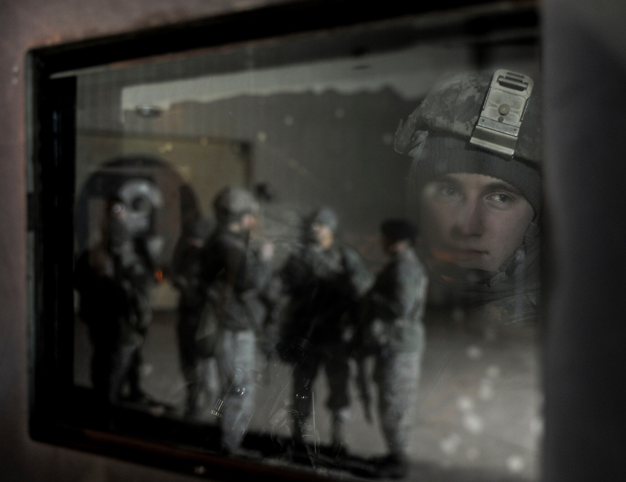 Airman 1st Class Zane Crady, 5th Security Forces Squadron response force team member, views his teammates from inside a humvee during a recapture exercise on Minot Air Force Base, N.D., April 4, 2015. Crady is part of a team of Airmen in charge of guarding and defending the base weapons storage area. (U.S. Air Force photo/Senior Airman Stephanie Morris)