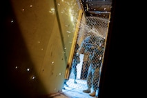 Senior Airman Jesus Contreras, 91st Security Forces Group tactical response force member uses an electric saw to cut through a fence during training on Minot Air Force Base, N.D., April 8, 2015. TRF is a nuclear special weapons and tactics team specializing in recapture and recovery operations. (U.S. Air Force photo/Senior Airman Brittany Y. Bateman)