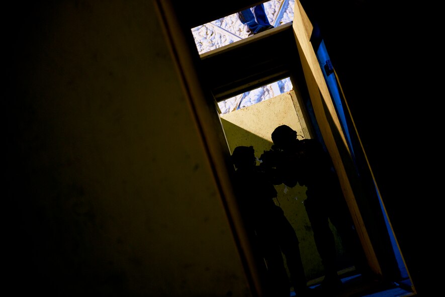 Members of the 91st Security Forces Group tactical response force practice building clearing techniques during training on Minot Air Force Base, N.D., April 8, 2015. TRF is a nuclear special weapons and tactics team specializing in recapture and recovery operations. (U.S. Air Force photo/Senior Airman Brittany Y. Bateman)