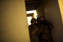 Members of the 91st Security Forces Group tactical response force practice building clearing techniques during training on Minot Air Force Base, N.D., April 8, 2015. TRF is a nuclear special weapons and tactics team specializing in recapture and recovery operations. (U.S. Air Force photo/Senior Airman Brittany Y. Bateman)