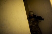 Members of the 91st Security Forces Group tactical response force practice building clearing techniques during training on Minot Air Force Base, N.D., April 8, 2015. TRF is a nuclear special weapons and tactics team specializing in recapture and recovery operations. (U.S. Air Force photo/Senior Airman Brittany Y. Bateman)