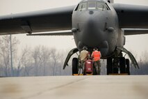 Crew chiefs from the 5th Aircraft Maintenance Squadron prepare a B-52H Stratofortress for takeoff on Minot Air Force Base, N.D., April 8, 2015. Crew chiefs are responsible for ensuring the aircraft is in perfect working condition. They also perform scheduled inspections and preventive maintenance on B-52s and the equipment installed inside the aircraft. Additionally crew chiefs also execute post-flight examinations to ensure the aircraft remains in ready condition. (U.S. Air Force photo/Senior Airman Brittany Y. Bateman)