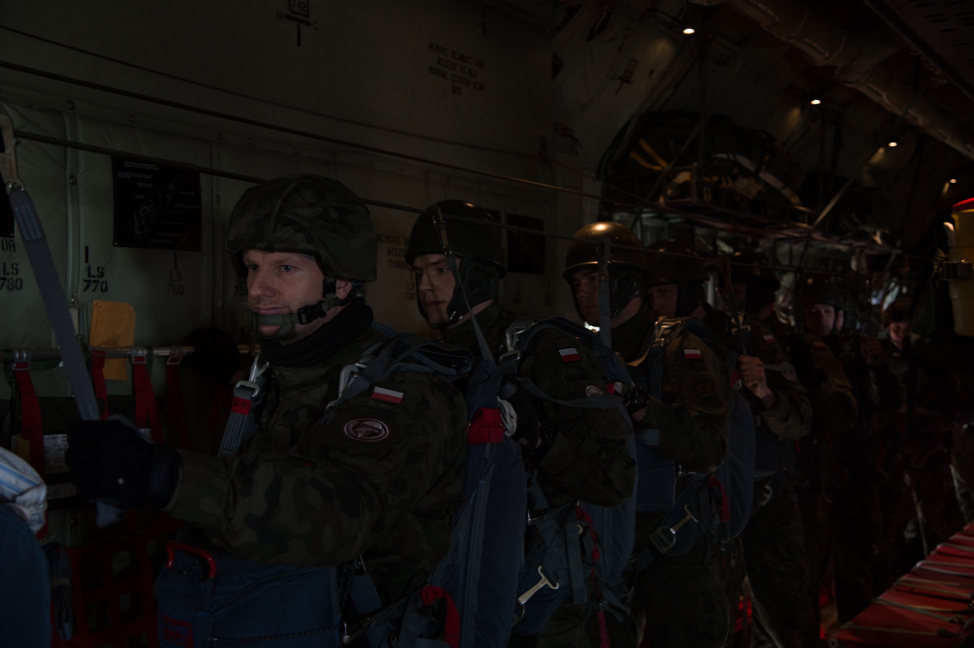 Poland air force paratroopers wait to jump from a C-130J Super Hercules assigned to the 37th Airlift Squadron during training above Krakow, Poland. Airmen from Ramstein Air Base, Germany arrived to Powidz Air Base, Poland as part of an aircraft rotation at the U.S. Aviation Detachment. U.S. forces worked alongside their Polish counterparts to build partnership and interoperability for future operations. (U.S. Air Force photo/Senior Airman Jonathan Stefanko)