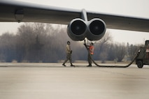 Crew chiefs from the 5th Aircraft Maintenance Squadron prepare a B-52H Stratofortress for takeoff on Minot Air Force Base, N.D., April 8, 2015. Crew chiefs are responsible for ensuring the aircraft is in perfect working condition. They also perform scheduled inspections and preventive maintenance on B-52s and the equipment installed inside the aircraft. Additionally crew chiefs also execute post-flight examinations to ensure the aircraft remains in ready condition. (U.S. Air Force photo/Senior Airman Brittany Y. Bateman)