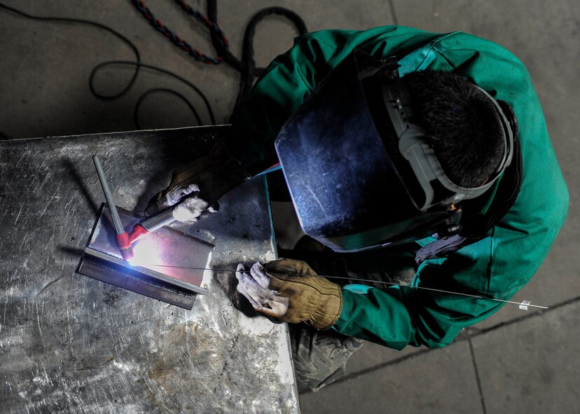 Senior Airman James Taber, 5th Aircraft Maintenance Squadron metals technology journeyman, welds together two pieces of metal on Minot Air Force Base, N.D., April 8, 2015. The base welding shop repairs a wide array of base equipment including aircraft and vehicle parts.  (U.S. Air Force photo/Senior Airman Stephanie Morris)