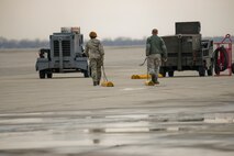 Airmen from the 5th Aircraft Maintenance Squadron pull chalks on the flightline on Minot Air Force Base, N.D., April 8, 2015. Crew chiefs are responsible for ensuring the aircraft is in perfect working condition. They also perform scheduled inspections and preventive maintenance on B-52s, and the equipment installed inside the aircraft. Additionally crew chiefs execute post-flight examinations to ensure the aircraft remains in ready condition. (U.S. Air Force photo/Senior Airman Brittany Y. Bateman)