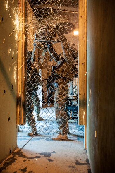 Senior Airman Ian Briggs, 791st Missile Security Forces Squadron tactical response force member, cuts through a fence during a training exercise on Minot Air Force Base, N.D., April 8, 2015. TRF perform exercises regularly to help maintain readiness. (U.S. Air Force photo/Airman 1st Class Christian Sullivan)