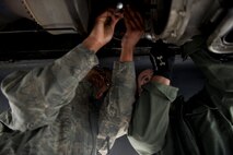 Airman 1st Class Mark Brown and Senior Airman Andrew Burts, 5th Aircraft Maintenance Squadron aerospace propulsion journeymen, changes the starter on a B-52H Stratofortress engine on Minot Air Force Base, N.D., April 8, 2015. Airmen from the propulsion flight ensure B-52H Stratofortress engines are in first-rate operational condition, which ensures the engines are fully capable to carry out any task a pilot may have is what the propulsion flight does every day. (U.S. Air Force photo/Senior Airman Brittany Y. Bateman)