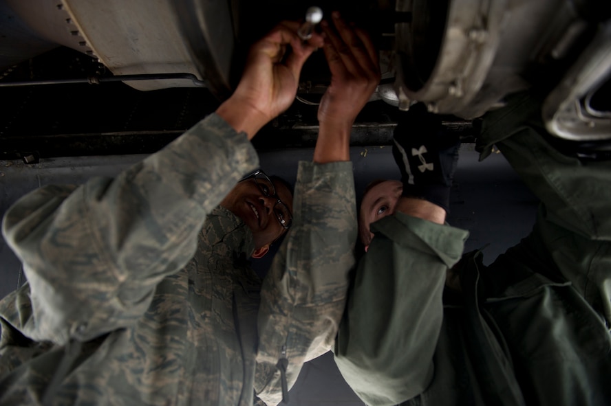 Airman 1st Class Mark Brown and Senior Airman Andrew Burts, 5th Aircraft Maintenance Squadron aerospace propulsion journeymen, changes the starter on a B-52H Stratofortress engine on Minot Air Force Base, N.D., April 8, 2015. Airmen from the propulsion flight ensure B-52H Stratofortress engines are in first-rate operational condition, which ensures the engines are fully capable to carry out any task a pilot may have is what the propulsion flight does every day. (U.S. Air Force photo/Senior Airman Brittany Y. Bateman)