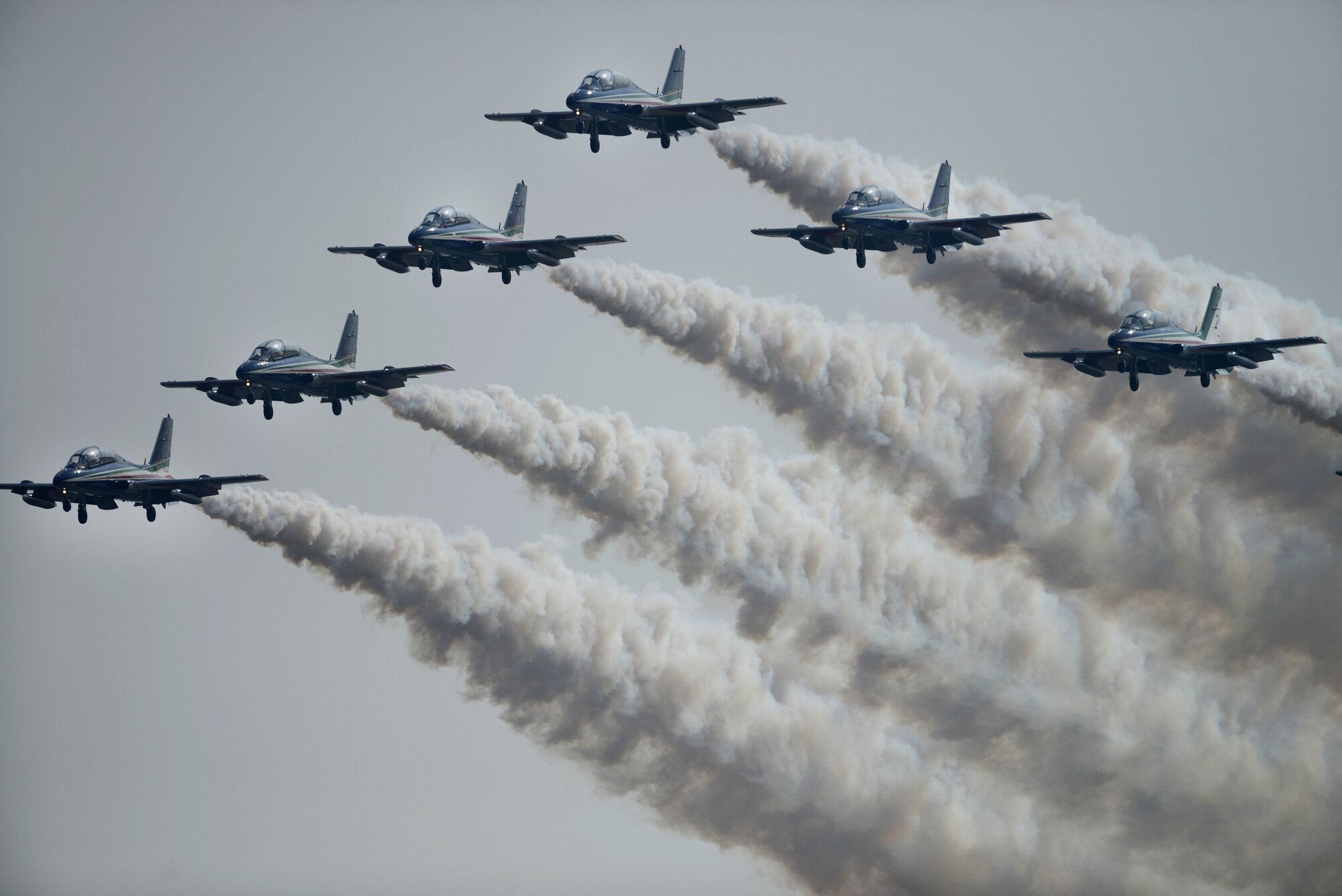 The Frecce Tricolori Italian air force aerobatics team, practices flying formations, April 10, 2015, at Aviano Air Base, Italy. Each year, they use the air space above Aviano to practice flying routines for their upcoming air show. (U.S. Air Force photo by Staff Sgt. Evelyn Chavez/Released)