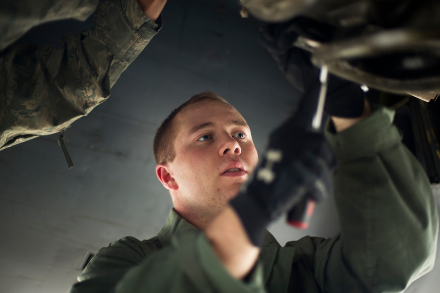 Senior Airman Andrew Burts, 5th Aircraft Maintenance Squadron aerospace propulsion journeyman, changes the starter on a B-52H Stratofortress engine on Minot Air Force Base, N.D., April 8, 2015. Airmen from the propulsion flight ensure B-52H engines are in first-rate operational condition. (U.S. Air Force photo/Senior Airman Brittany Y. Bateman)