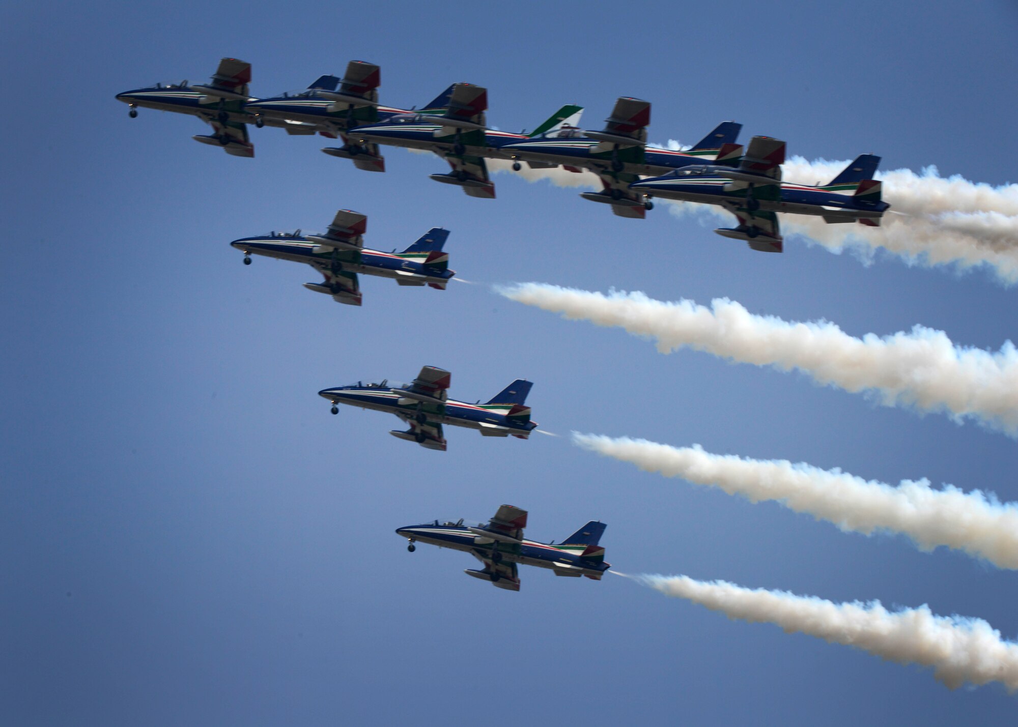 The Frecce Tricolori Italian air force aerobatics team, practices flying formations, April 10, 2015, at Aviano Air Base, Italy. Each year, they use the air space above Aviano to practice flying routines for their upcoming air show. (U.S. Air Force photo by Senior Airman Areca T. Wilson/Released)