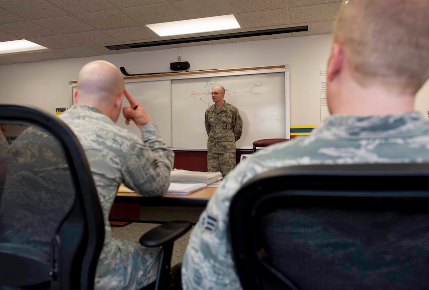 Staff Sgt. Donald Nelson, 5th Force Support Squadron Airman Leadership School instructor, teaches students on Minot Air Force Base, N.D., April 8, 2015. ALS prepares students for the transition from an Airman to a noncommissioned officer. (U.S. Air Force photo/Airman 1st Class Sahara L. Fales)