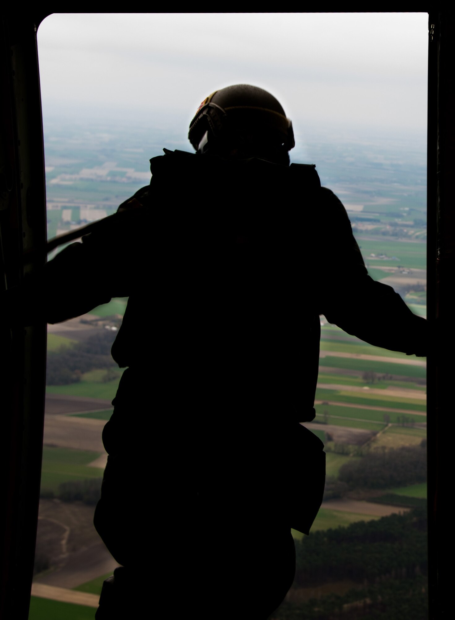 An Airman from the 435th Contingency Response Group looks out of a C-130J Super Hercules April 8, 2015 above Powidz Air Base, Poland. Armed Forces from Ramstein Air Base, Germany arrived in Poland during an aircraft rotation to train with Polish counterparts. (U.S. Air Force photo/Senior Airman Jonathan Stefanko)