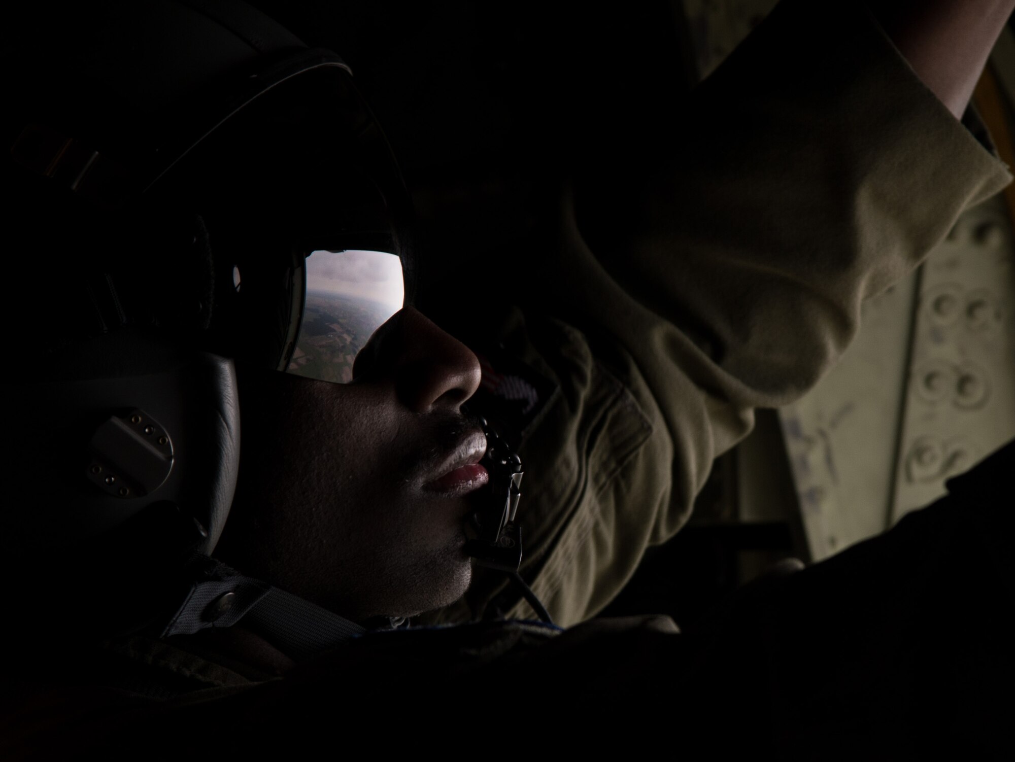 Airman 1st Class Brandon Ravenell, 37th Airlift Squadron loadmaster, closes a door on a C-130J Super Hercules April 8, 2015 above Powidz Air Base, Poland. Armed Forces from Ramstein Air Base, Germany arrived to Poland during an aircraft rotation to train with Polish counterparts. (U.S. Air Force photo/Senior Airman Jonathan Stefanko)