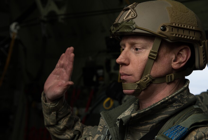Master Sgt. James Burke, 435th Contingency Response Group airfield manager, re-enlists while flying in a C-130J Super Hercules April 8, 2015 above Powidz Air Base, Poland. While deployed to Poland for training Burke re-enlisted into the Air Force on a C-130J before parachuting out. (U.S. Air Force photo/Senior Airman Jonathan Stefanko) 

