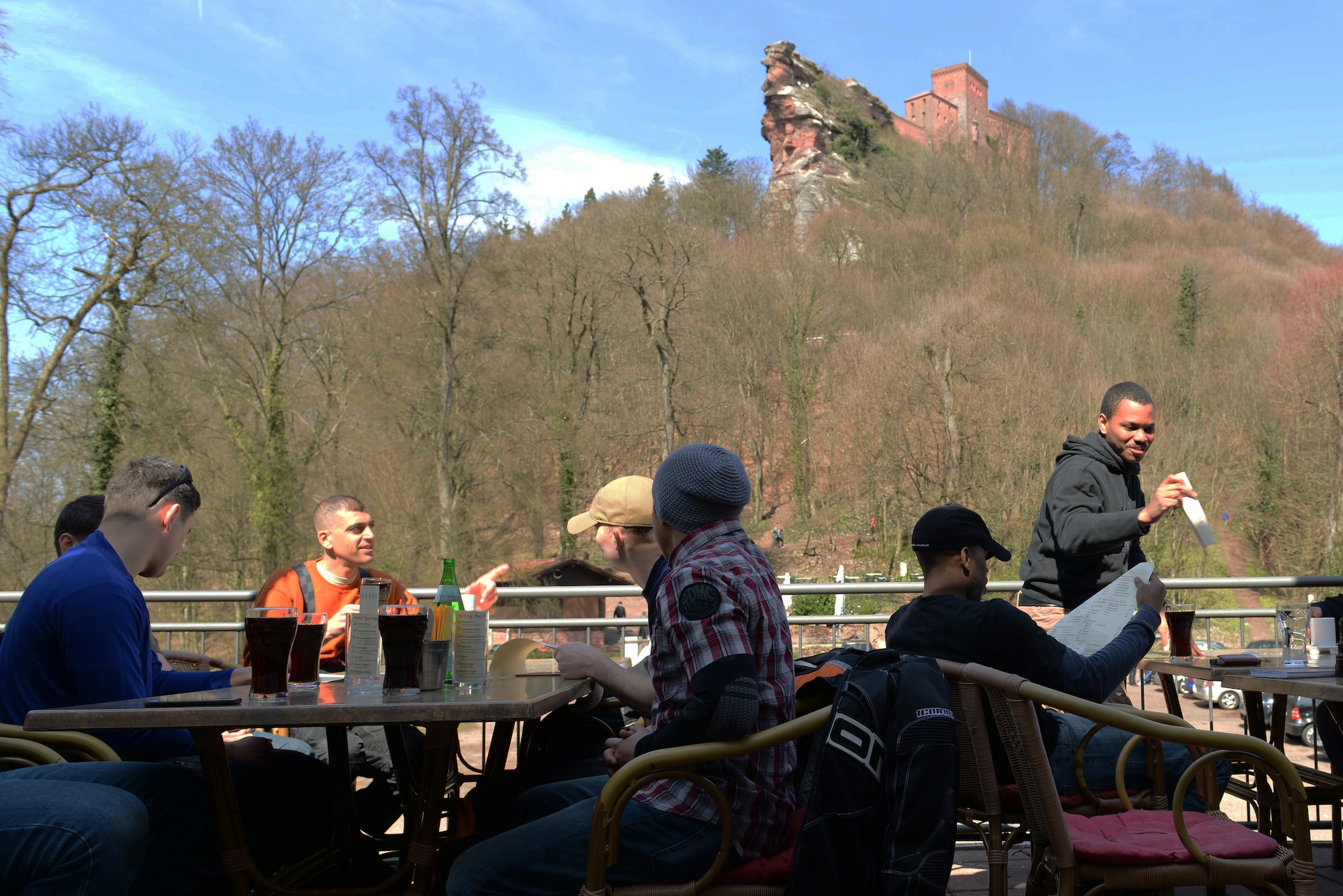 Airmen from the 86th Civil Engineer Group eat lunch at a café beneath Trifels Castle, Annweiler as a part of the 86th CEG Motorcycle Safety Day, April 7, 2015. The safety day consisted of a 90-mile round-trip ride to the castle, which offered a wide variety of terrain for new riders to gain experience before the start of the motorcycle riding season. (U.S. Air Force photo/Airman 1st Class Tryphena Mayhugh))