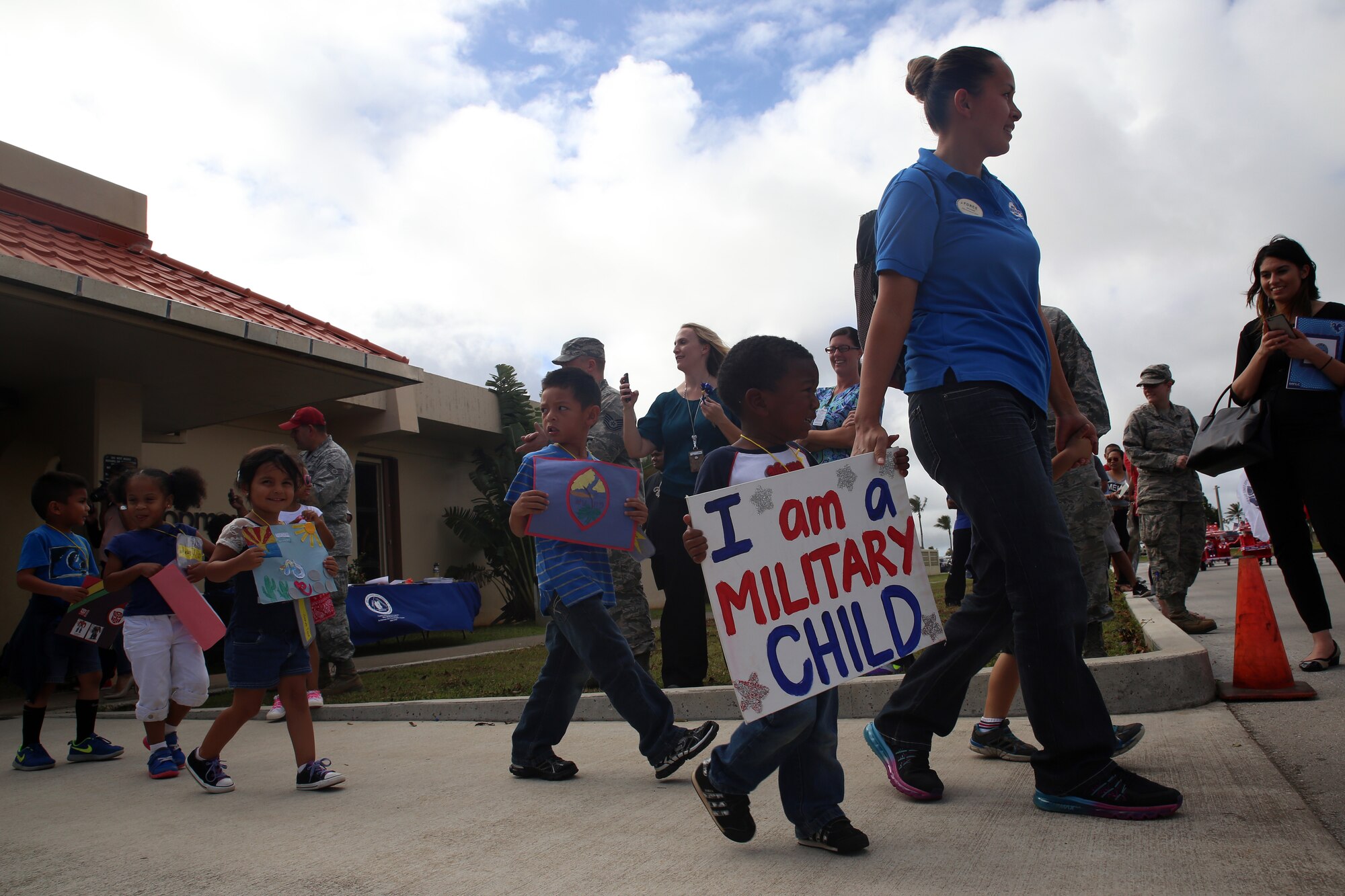 Andersen Child Development Center children and staff participate in a parade April 10, 2015, at Andersen Air Force Base, Guam, to celebrate the Month of the Military Child. April was designated as the Month of the Military Child in 1986 to recognize sacrifices and contributions of children in the armed forces community. (U.S. Air Force photo by Staff Sgt. Melissa B. White/Released)