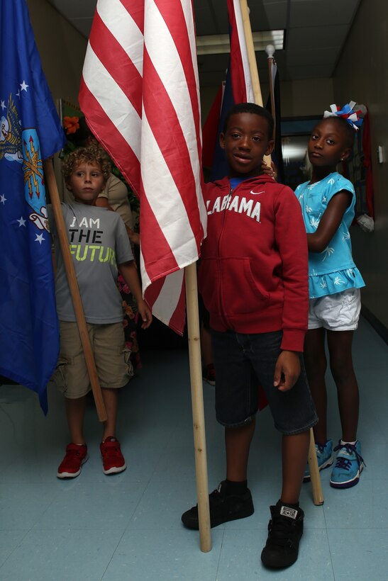 Andersen Child Development Center children wait to take part in a parade April 10, 2015, at Andersen Air Force Base, Guam, to celebrate the Month of the Military Child. April was designated as the Month of the Military Child in 1986 to recognize sacrifices and contributions of children in the armed forces community. (U.S. Air Force photo by Staff Sgt. Melissa B. White/Released)
