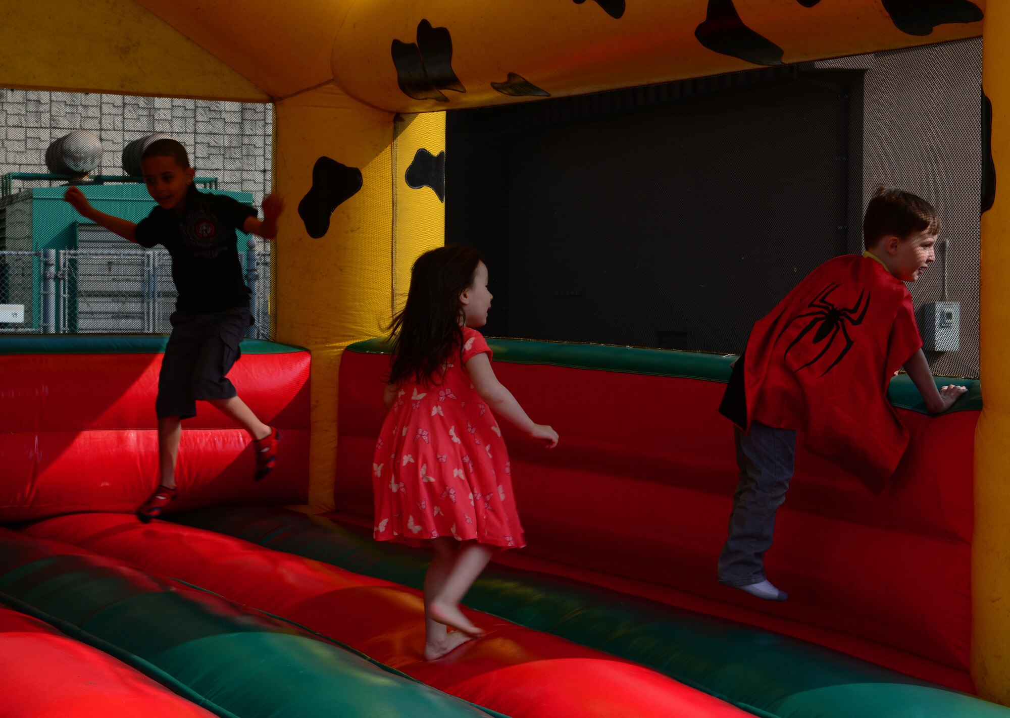 Children play inside a bouncy castle during the kick-off of 51 days of resiliency April 10, 2015, at Osan Air Base, Republic of Korea. Throughout this expansive and unprecedented program, Team Osan is set to stampede to the front with almost two months of daily activities and offered programs in an effort to foster resiliency skills across all members. (U.S. Air Force photo by Staff Sgt. Benjamin Sutton/Released)