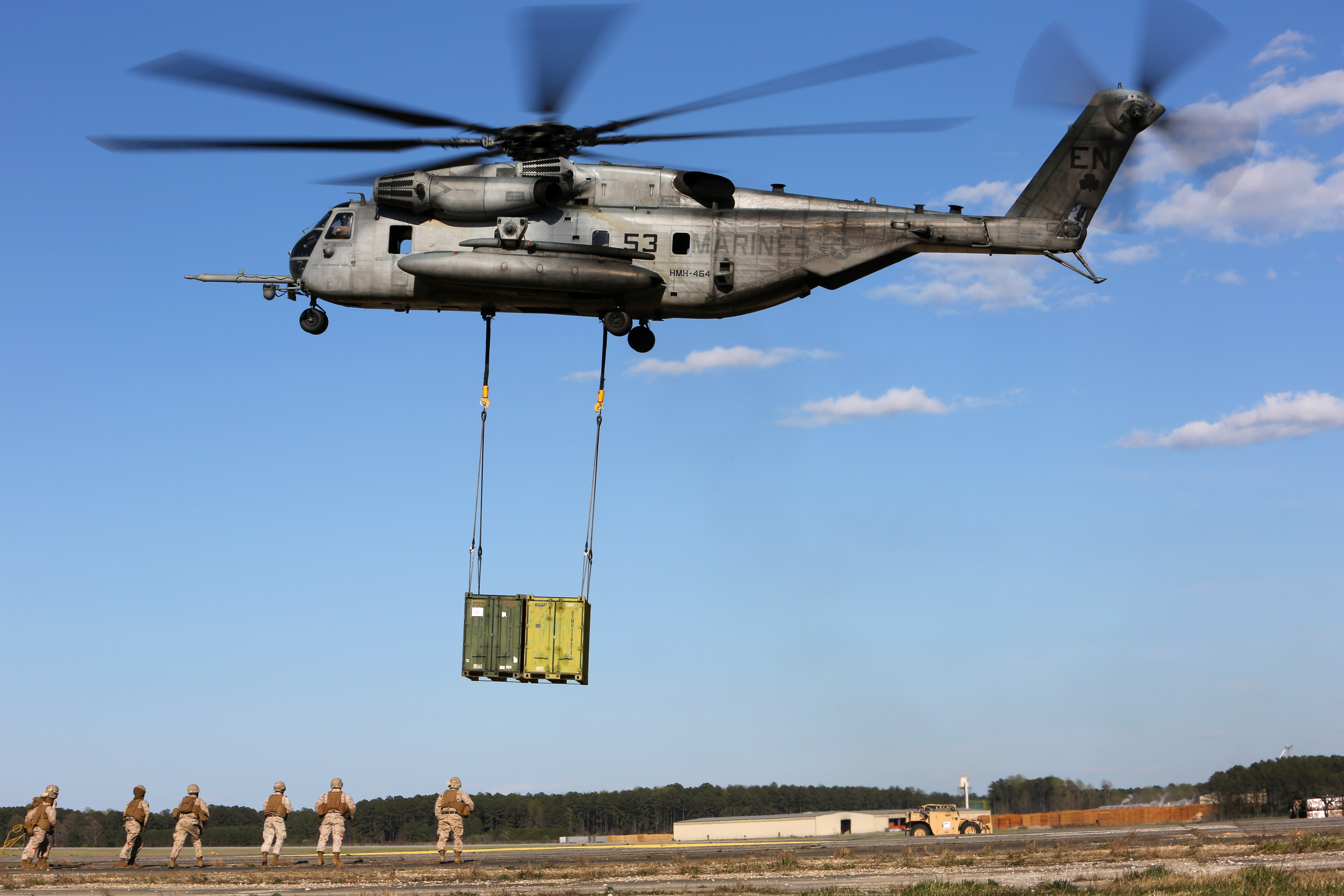 A CH53E Super Stallion helicopter lifts containers during helicopter