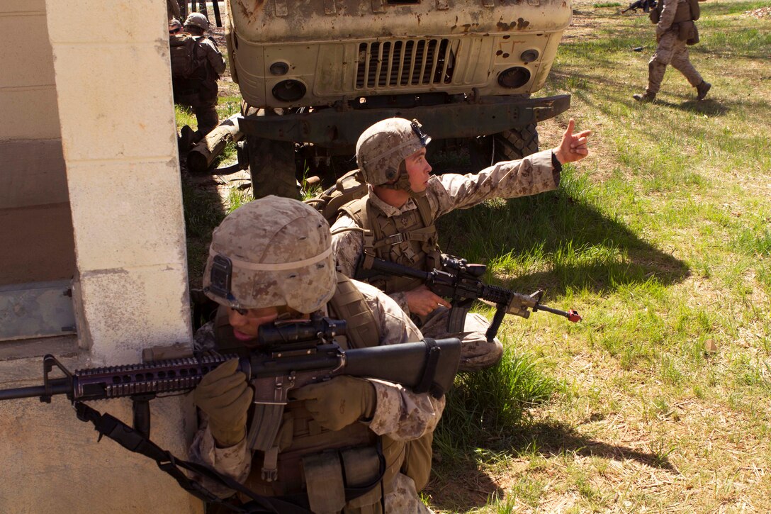 A Marine calls for reinforcements during urban operations training on Fort Pickett, Va., April 11, 2015.
