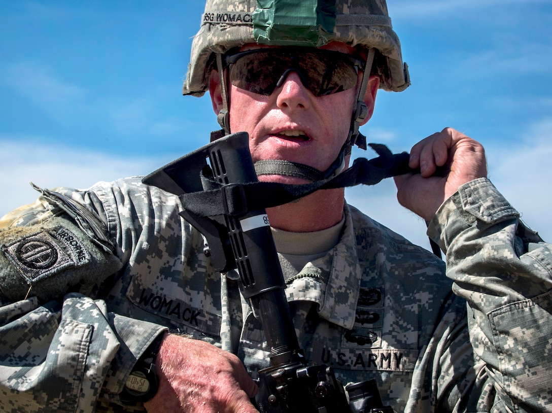U.S. Army Staff Sgt. Jason Womack slings his M-4 carbine rifle after packing his parachute and completing a static-line jump during the Combined Joint Operational Access Exercise 15-01 on Fort Bragg, N.C., April 11, 2015. Womack is a combat medic assigned to the 82nd Airborne Division's 3rd Brigade Combat Team.