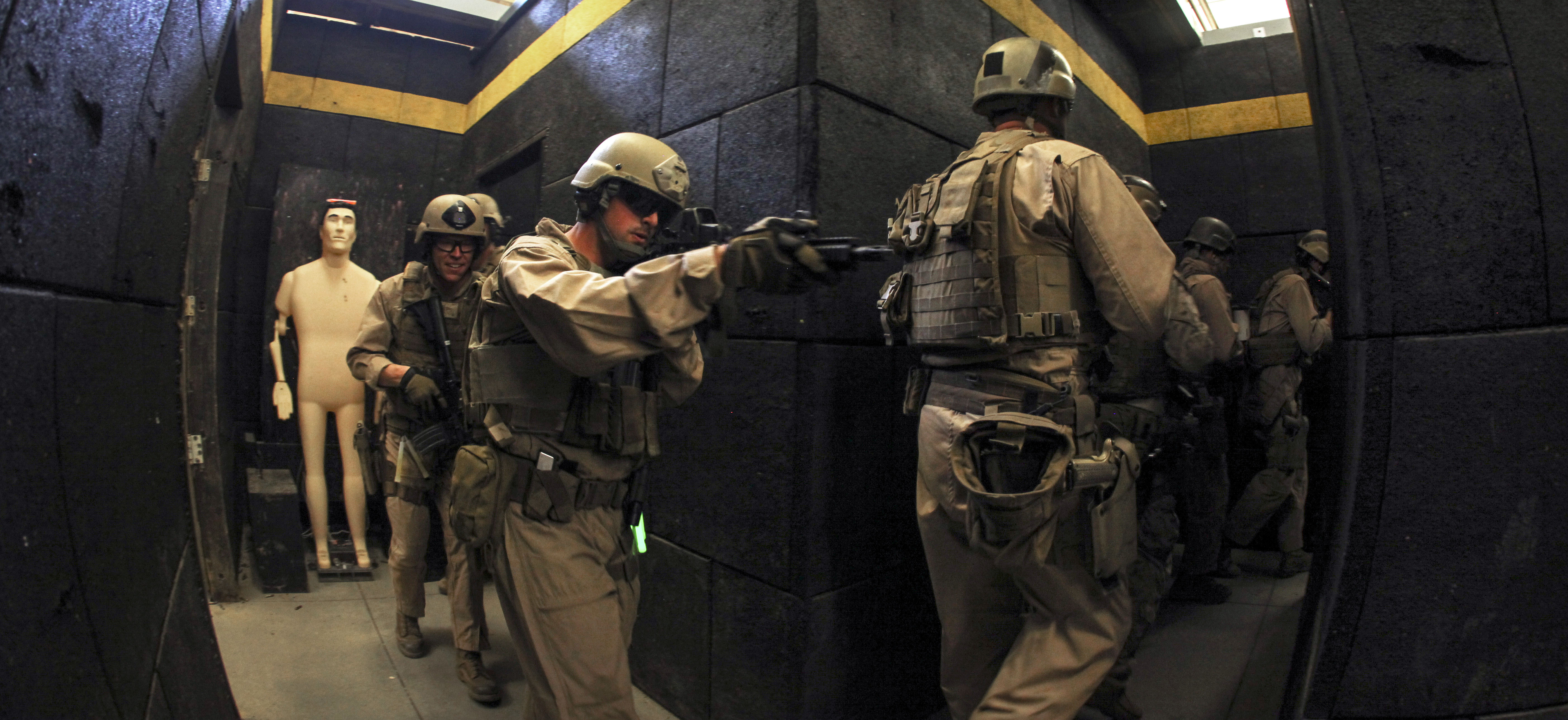 Marines conduct livefire room clearing drills at a shoot house on Fort