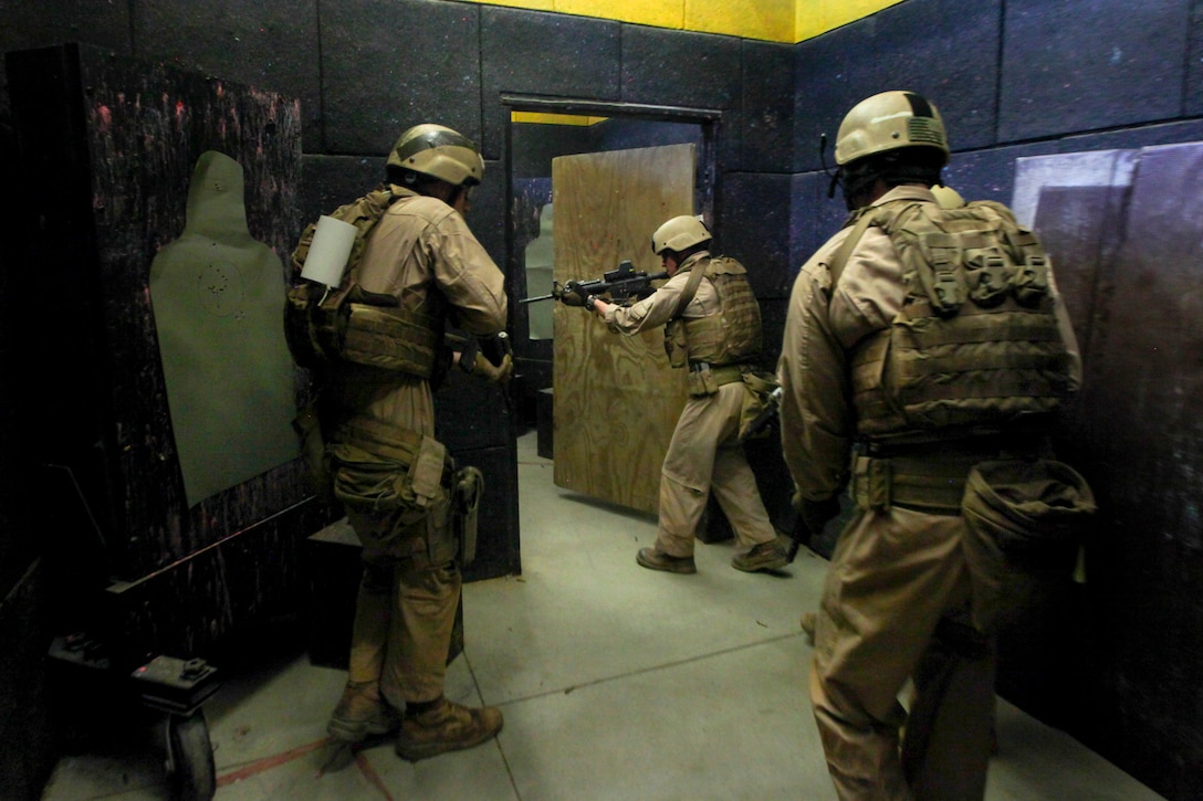 Marines secure rooms as they conduct live-fire room clearing drills at a shoot house on Fort Pickett, Va., April 11, 2015.