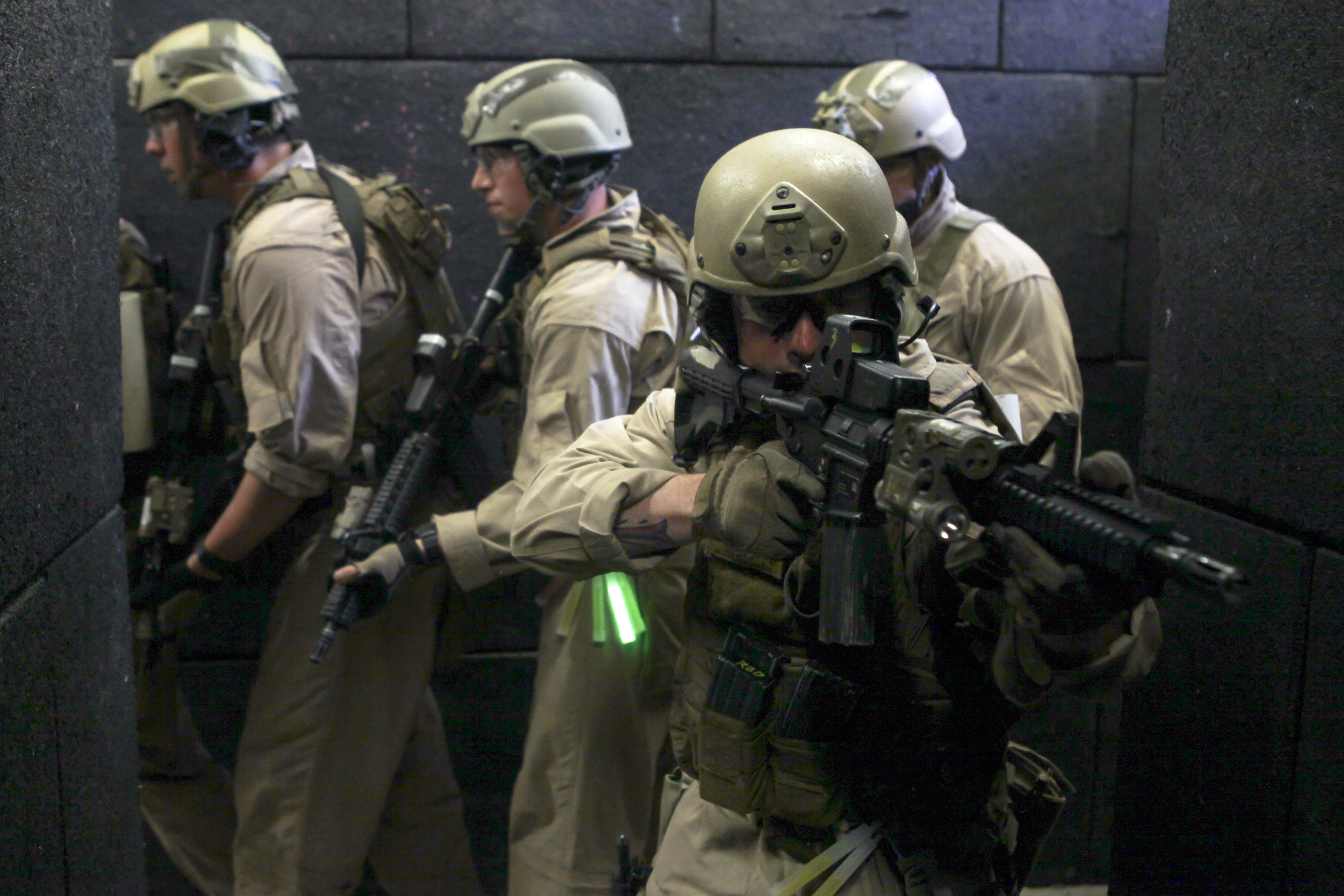 Marines clear a hallway while conducting livefire room clearing drills