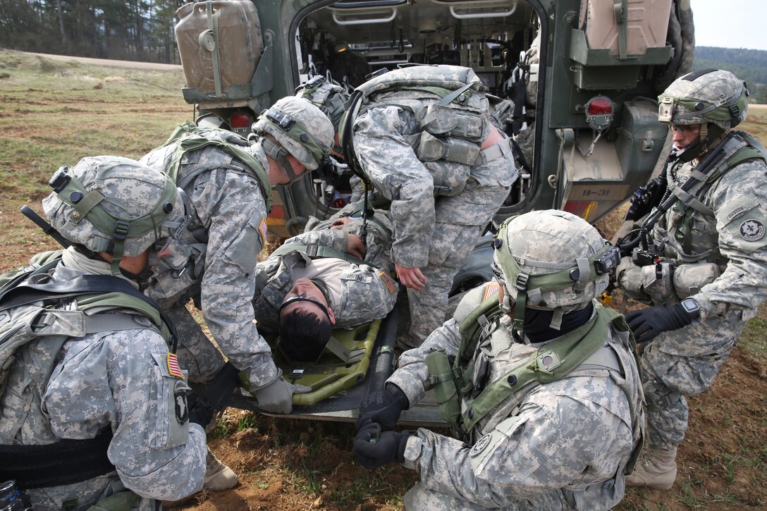 U.S. soldiers prepare to medically evacuate a simulated wounded soldier during exercise Saber Junction 15 at the U.S. Army Joint Multinational Readiness Center in Hohenfels, Germany, April 12, 2015.  The soldiers are assigned to the 2nd Cavalry Division, Bravo Troop, 1st Squadron.