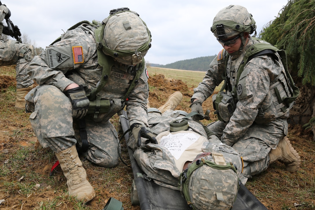U.S. soldiers strap a simulated wounded soldier to a litter during exercise Saber Junction 15 at the U.S. Army Joint Multinational Readiness Center in Hohenfels, Germany, April 12, 2015.