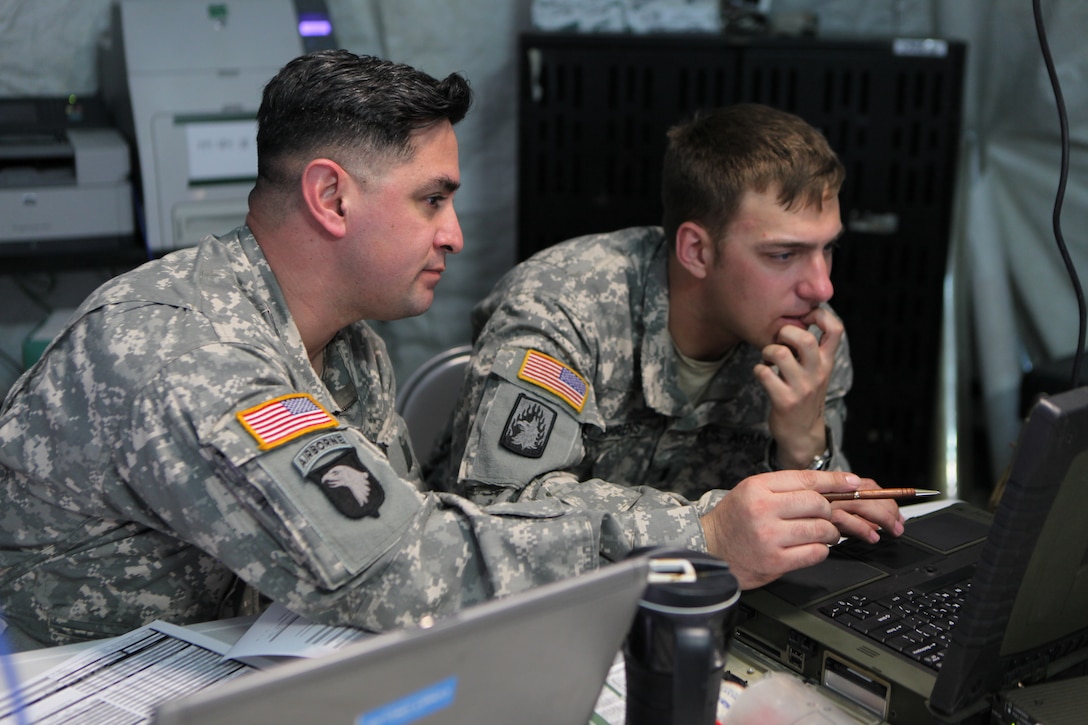 U.S. Army Chief Warrant Officer 4 Salvador Chavez, left, and 1st Lt. Josh Ahrens create a PowerPoint presentation during exercise Saber Junction 15 at the U.S. Army’s Joint Multinational Readiness Center in Hohenfels, Germany, April 12, 2015. 