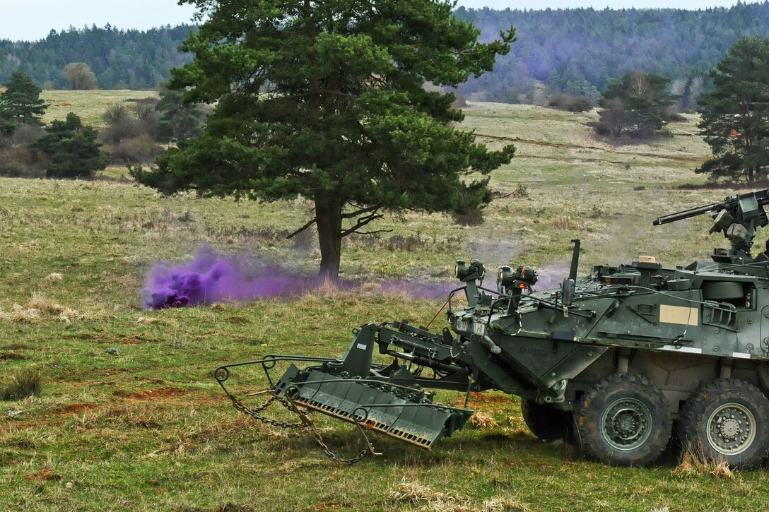 U.S. soldiers use purple smoke to mark a mined area while conducting breach training as part of exercise Saber Junction 15 on the Grafenwoehr Training Area in Germany, April 13, 2015.