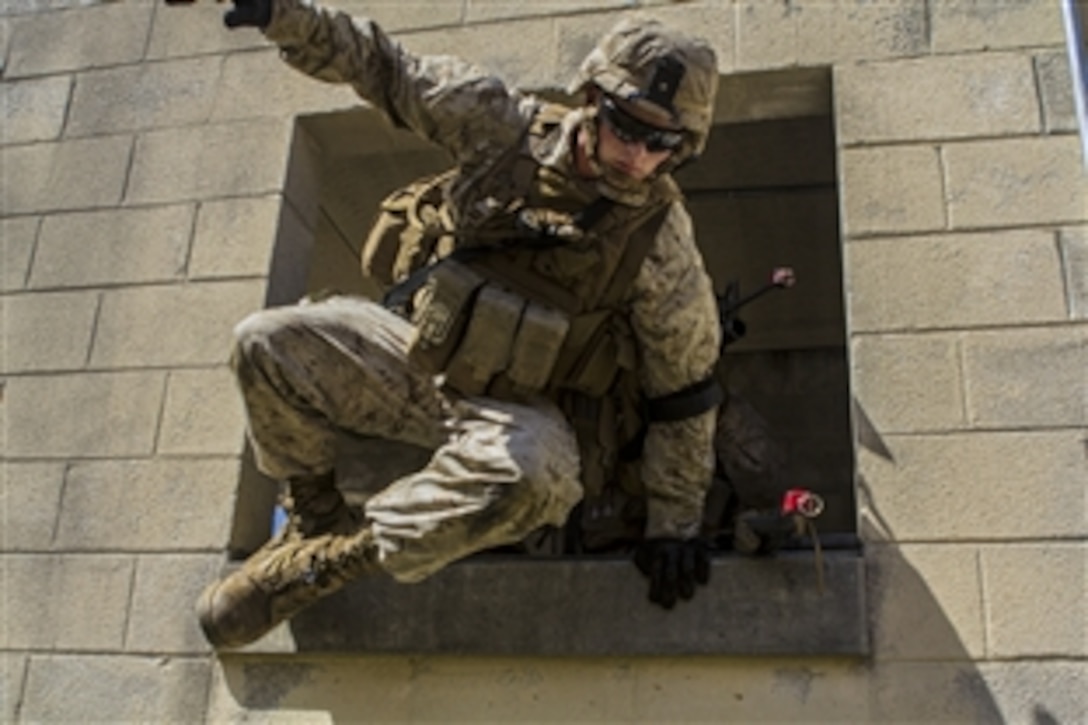 A Marine exits a building through a window during military operations in urban terrain training on 
Fort Pickett, Va., April 11, 2015. The Marines are assigned to Golf Company, Battalion Landing Team, 2nd Battalion, 6th Marine Regiment, 26th Marine Expeditionary Unit. 