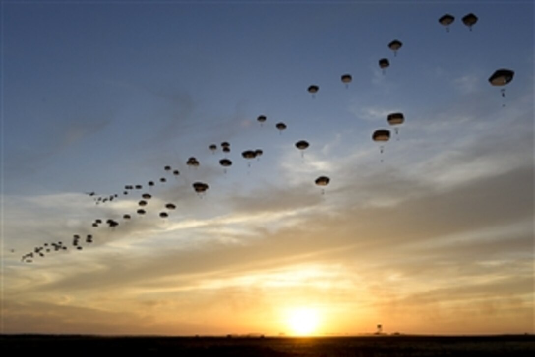 U.S. and British paratroopers perform a static line jump over Holland Drop Zone in preparation for Combined Joint Operational Access Exercise 15-01 on Fort Bragg, N.C., April 11, 2015. The U.S. paratroopers are assigned to the 82nd Airborne Division.