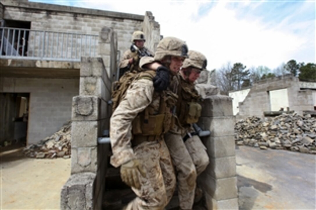 Marines carry a simulated casualty to an aerial landing zone during an urban training exercise on Fort Pickett, Va., April 11, 2015. 