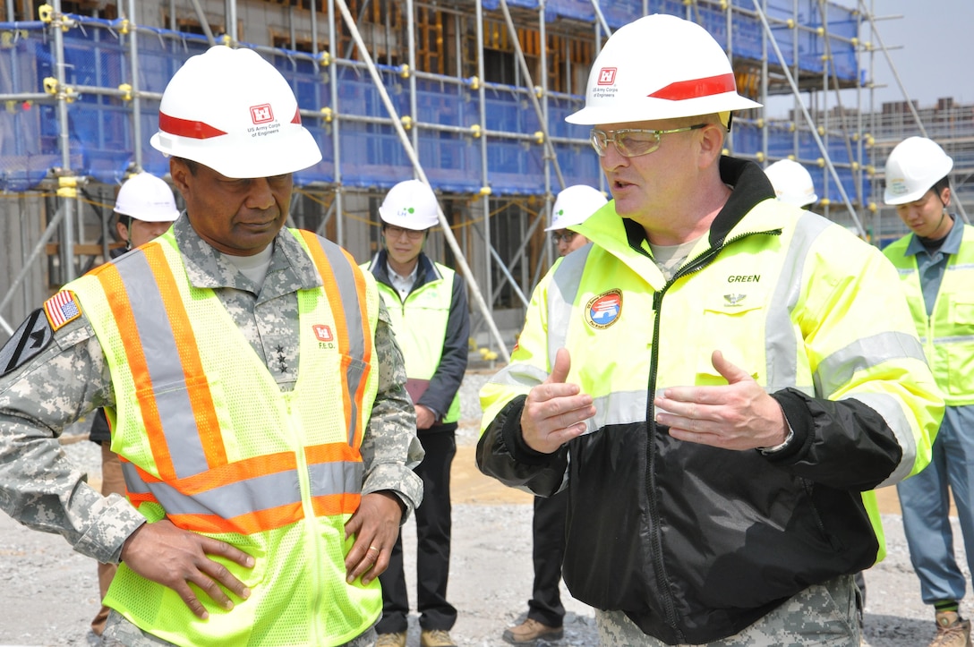 Lt. Gen. Thomas P. Bostick, commanding general of the U.S. Army Corps of Engineers (USACE) and 53rd Chief of Engineers, discusses the U.S. Army Garrison Humphreys "downtown" construction project with Col. Bryan S. Green on April 8, 2015.